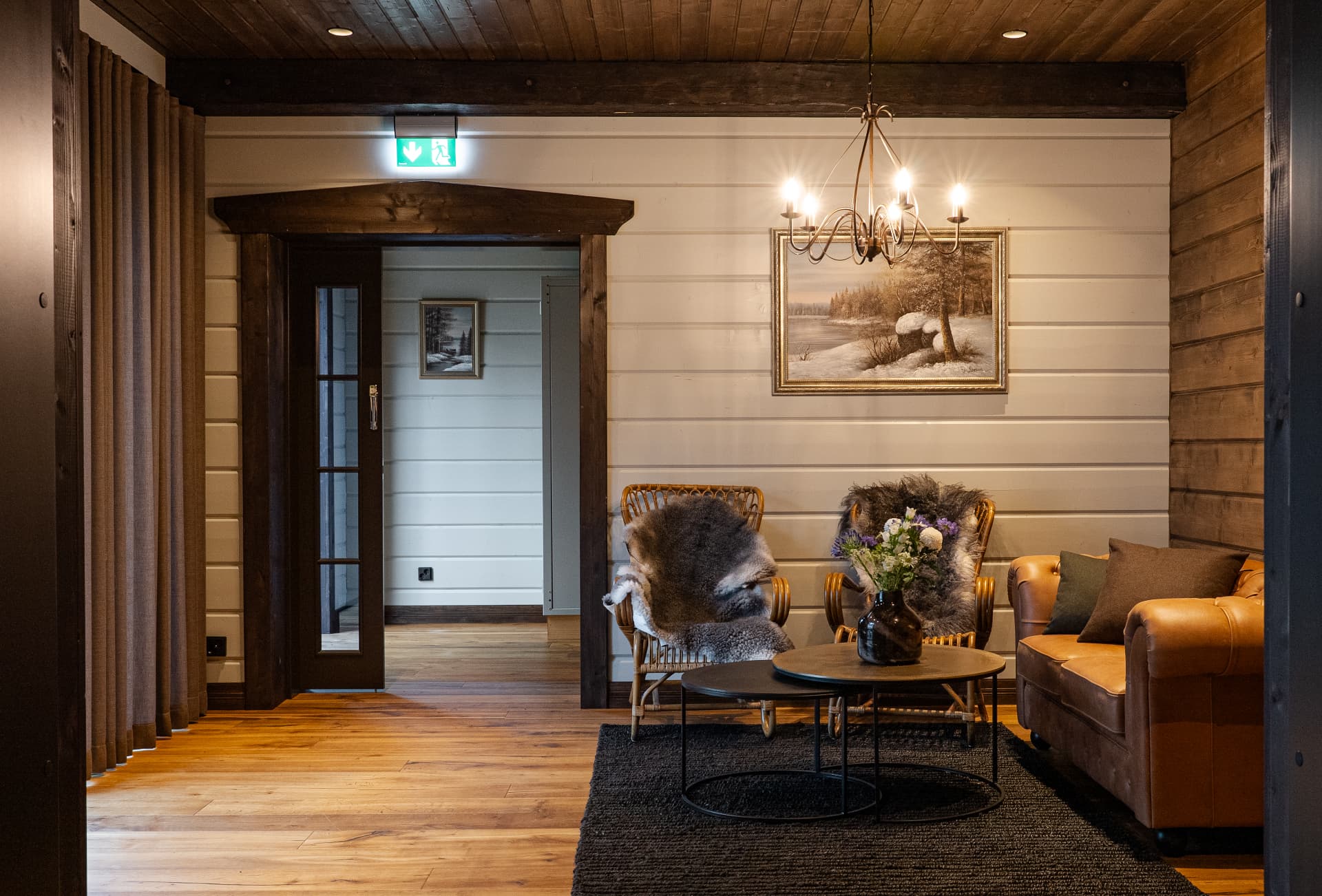 Chandelier-lit lounge in the great hall of Neituri Manor, Nordic luxury in the Finnish countryside