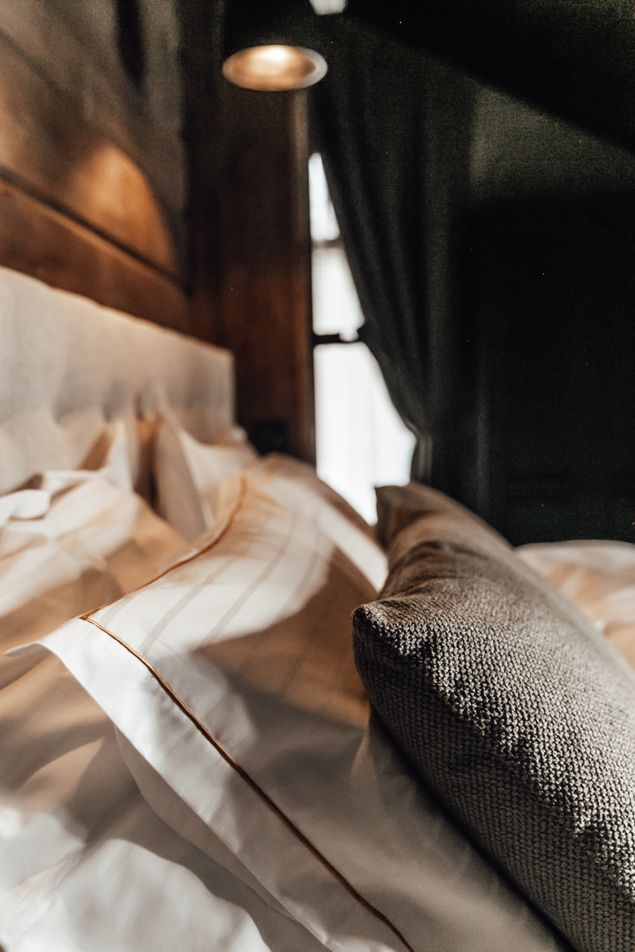 Master bedroom with timber walls and lake light at Neituri Manor, exclusive accommodation in Finland