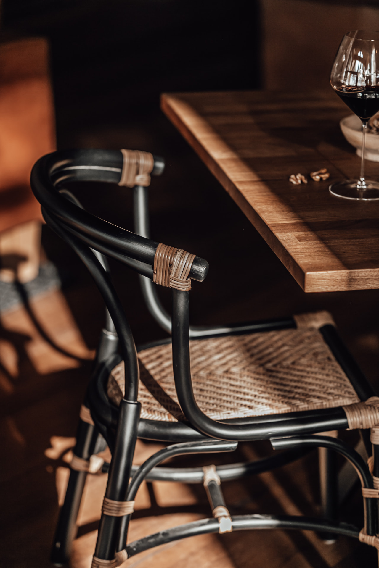 Glass of red wine on the oak table in the tavern at Neituri Manor, private dining in Finland