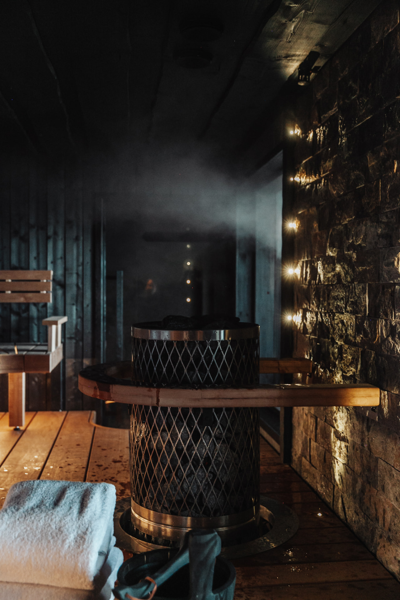 Timber bench room of the private Finnish sauna at Neituri Manor beside the lake